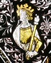 A fragment of mediaeval stained glass survives above the Mugliston window